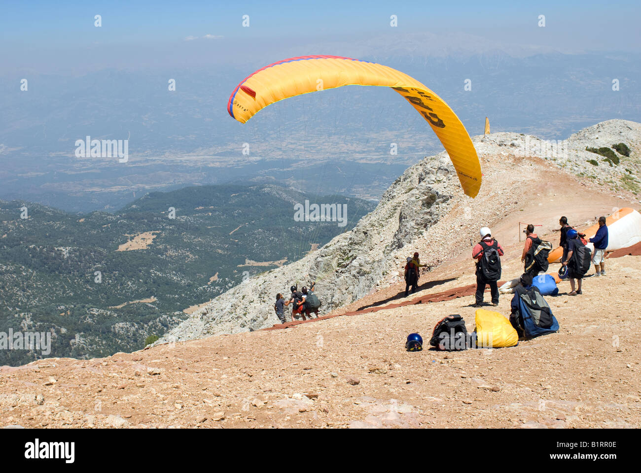 Paragliding off Babadag mountain in Fethiye, Mugla Turkey landing on Olu Deniz Beach, a popular holiday makers Stock Photo