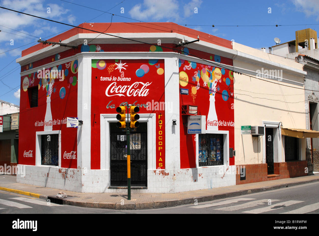 Corner house with bright red advertising, Ciudad de Salta, Salta Province, Argentina, South America Stock Photo