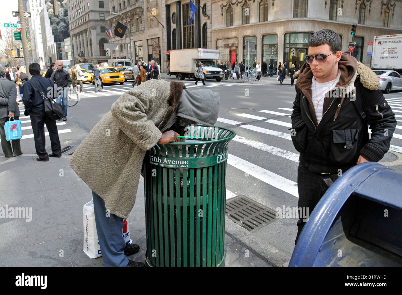 NY homeless man holding an LV bag pulled from a trash can. A few