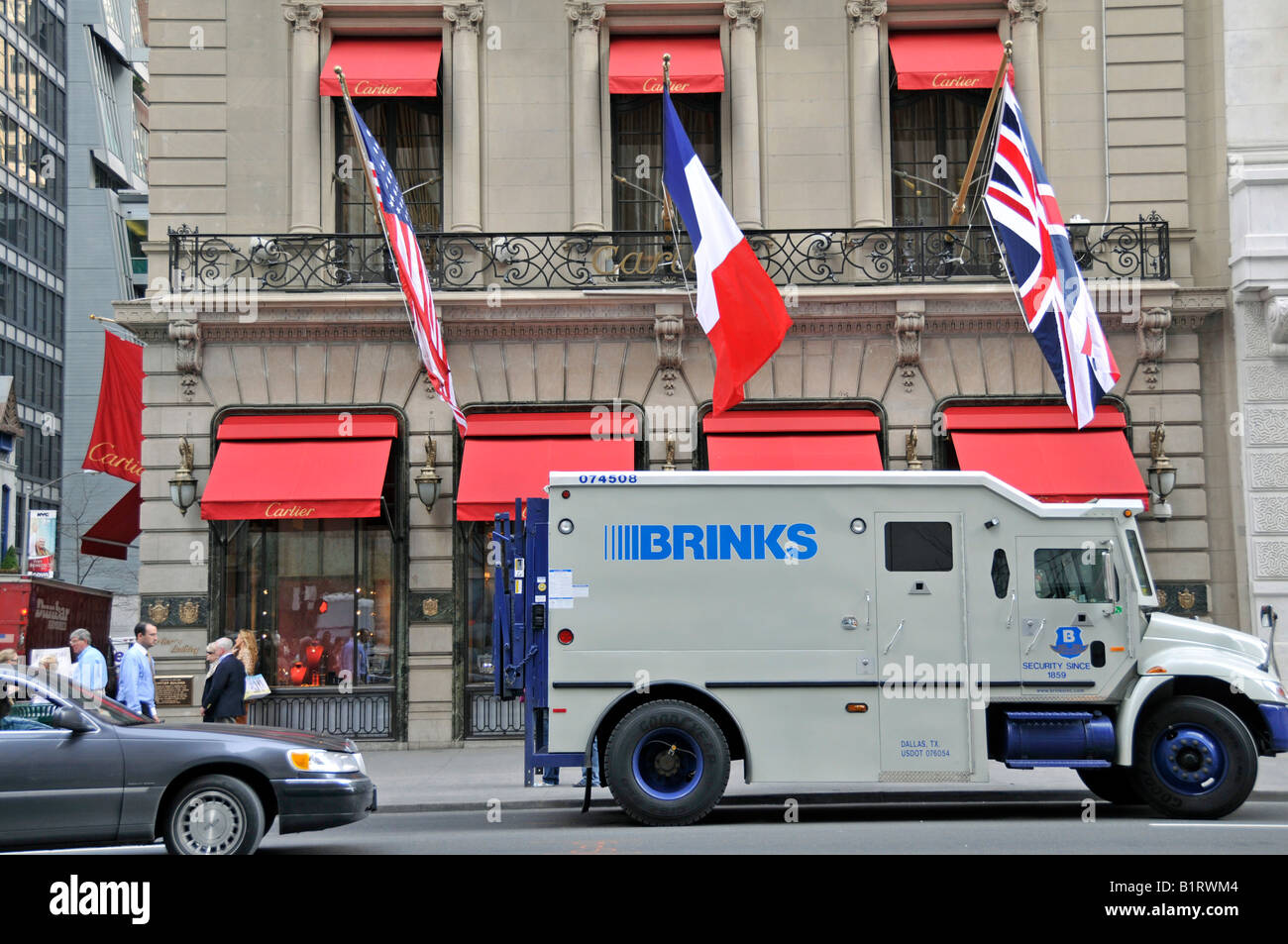 Retail shop of the exclusive French jewellery and watch company Cartier behind an armoured security vehicle, Brinks truck, Manh Stock Photo