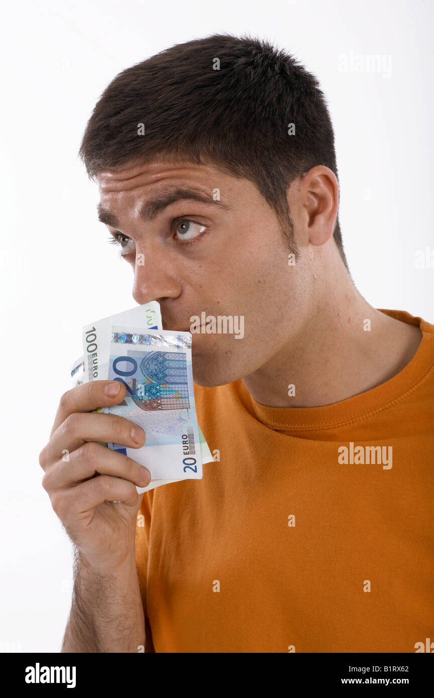 Man smelling money, cash Stock Photo