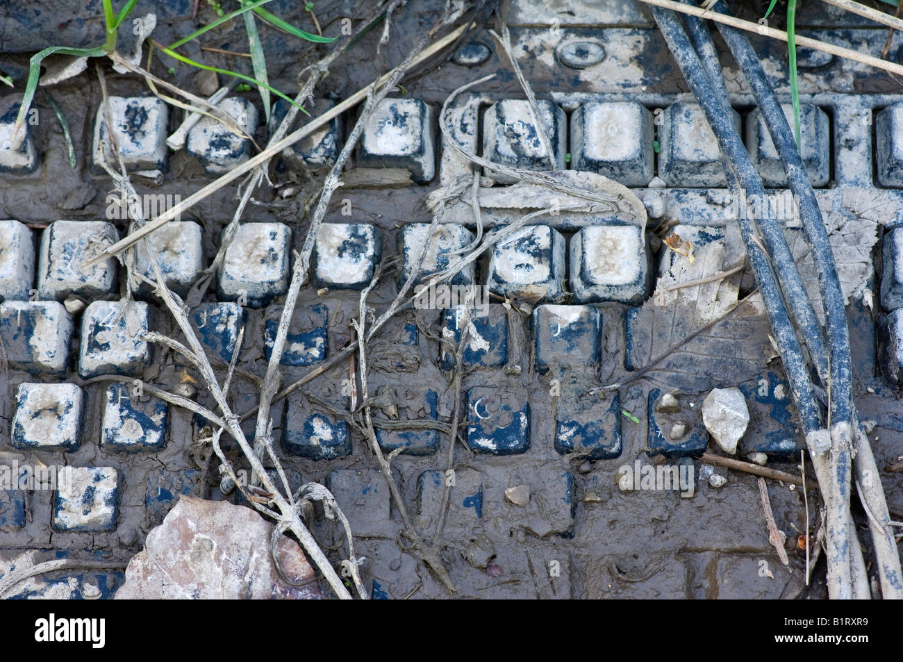 Computer keyboard covered in mud Stock Photo