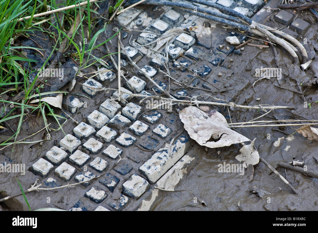 Computer keyboard covered in mud Stock Photo