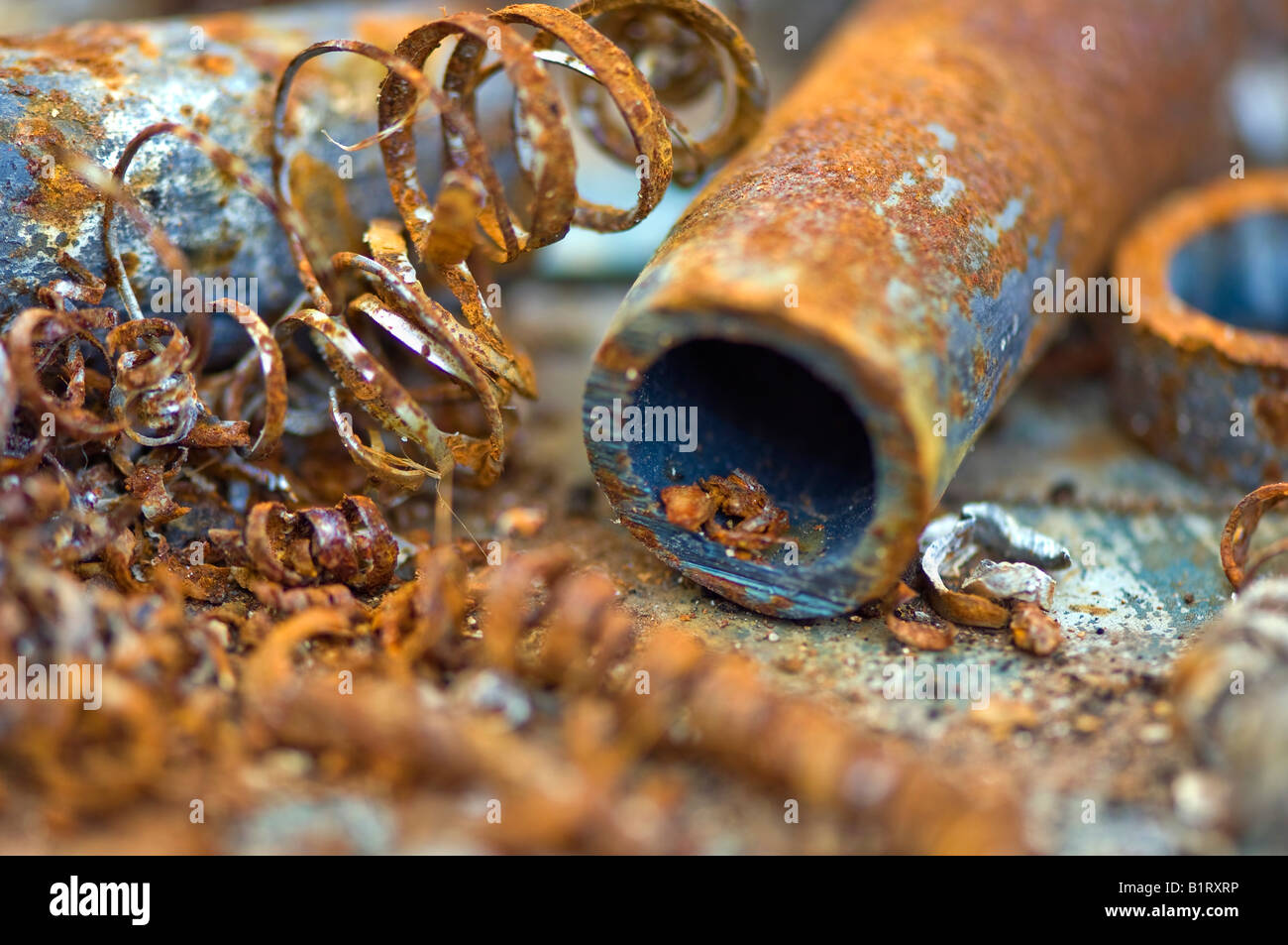 Rusty water pipes and rusty chips of iron Stock Photo