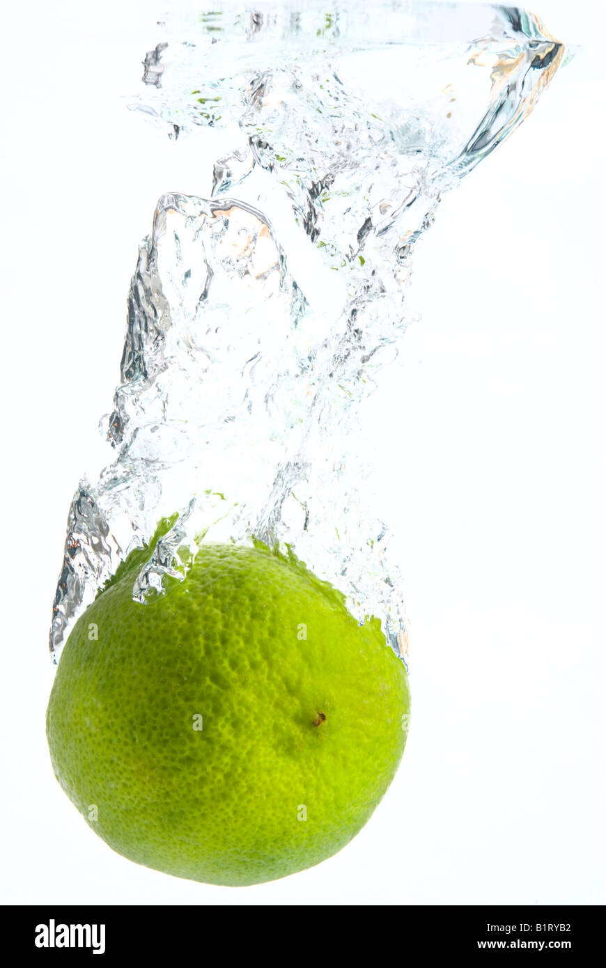 Lime plunging into water Stock Photo