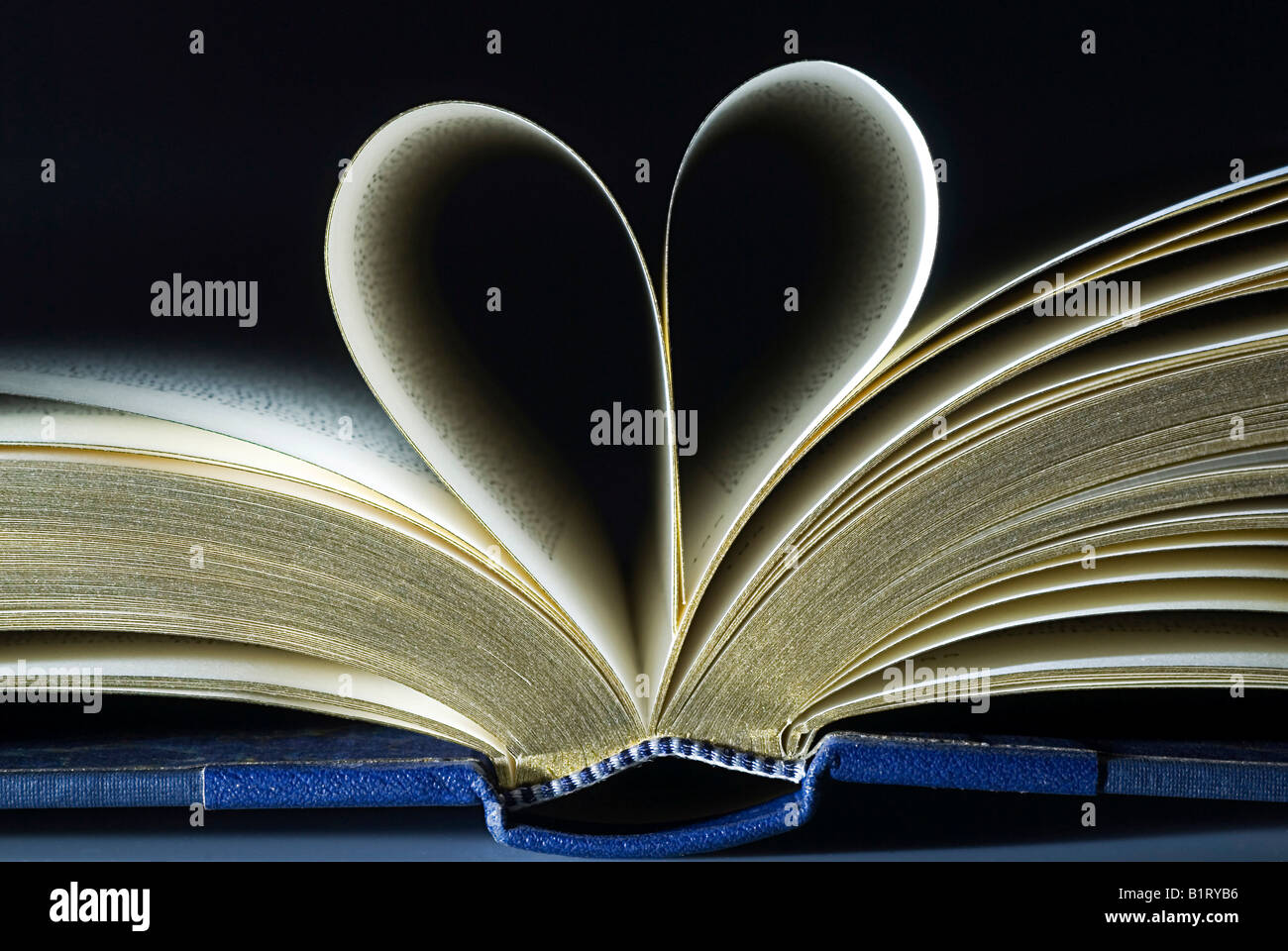Open book, two pages folded into the shape of a heart Stock Photo