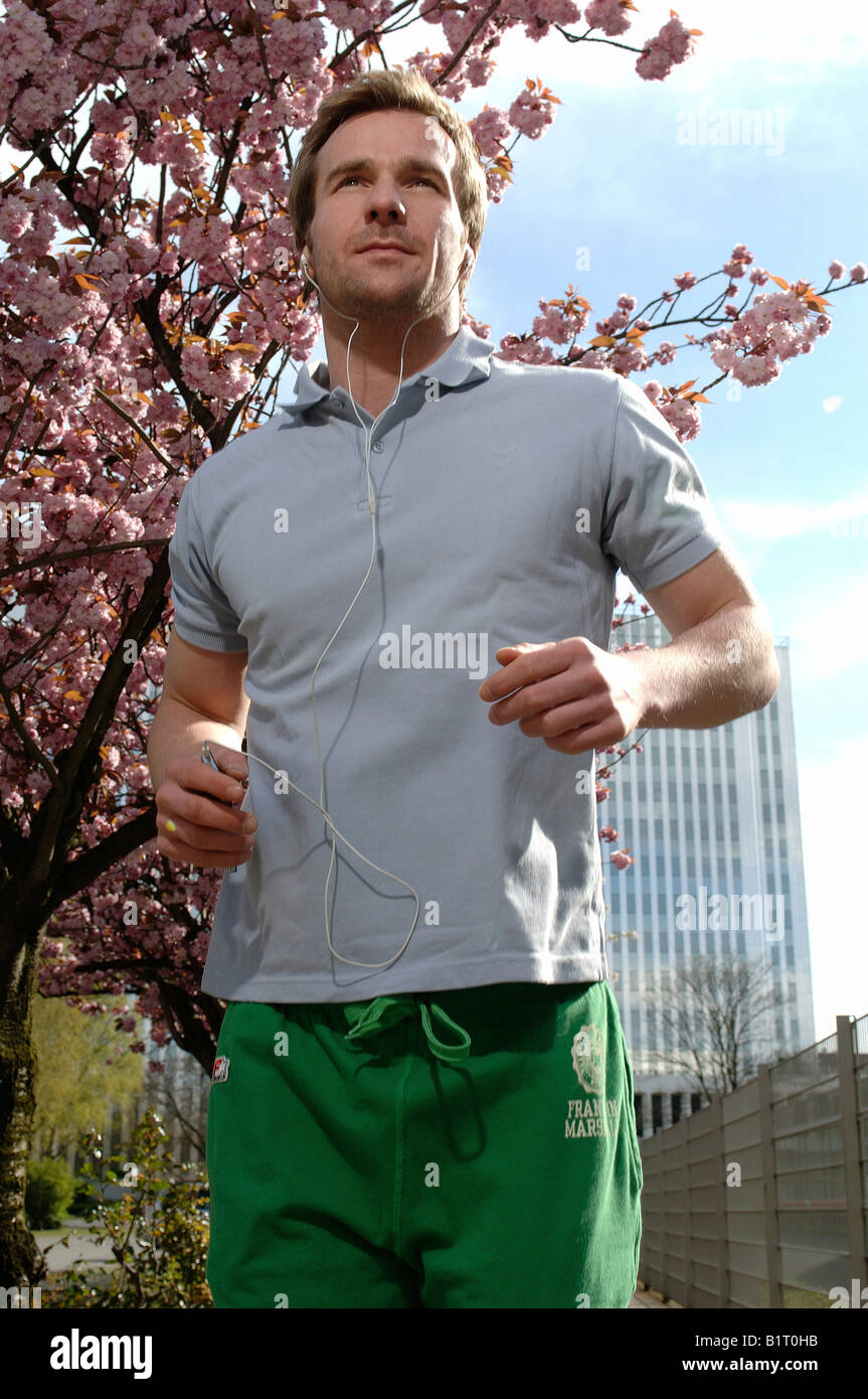 33 year-old man jogging in the city in spring Stock Photo