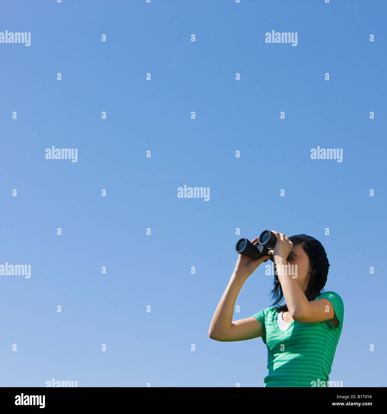 A teenager looks through binoculars Stock Photo