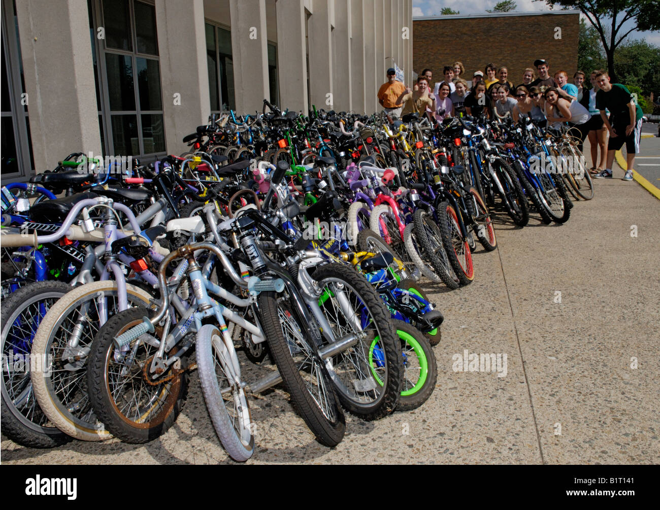 High school environment club, teens, volunteering at bike recycling collection, posing with the day's collection. Stock Photo