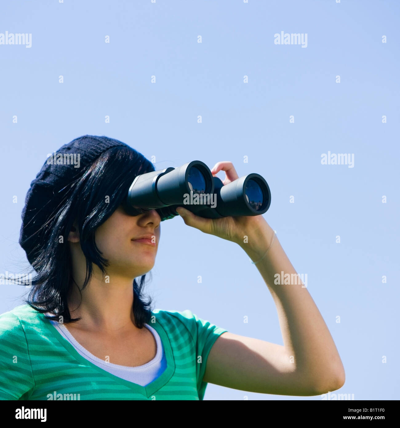A teenager looks through binoculars Stock Photo