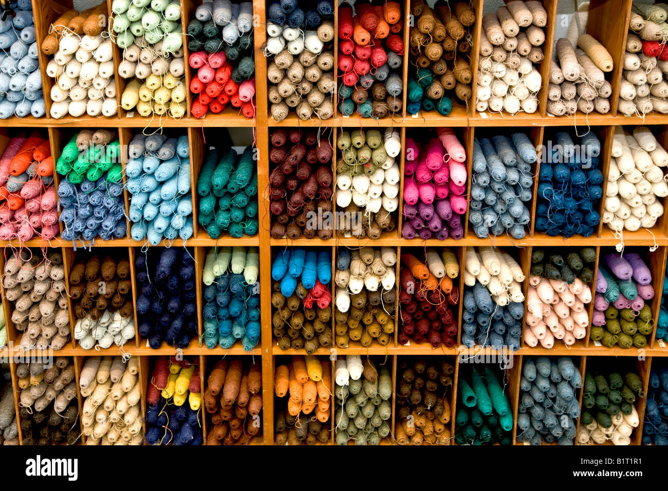 Shelves of colourful yarn spools Stock Photo - Alamy