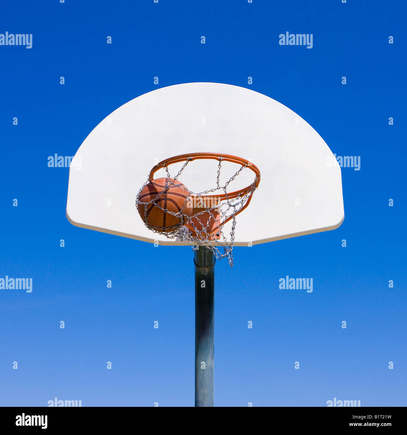 A basketball goes through hoop Stock Photo Alamy