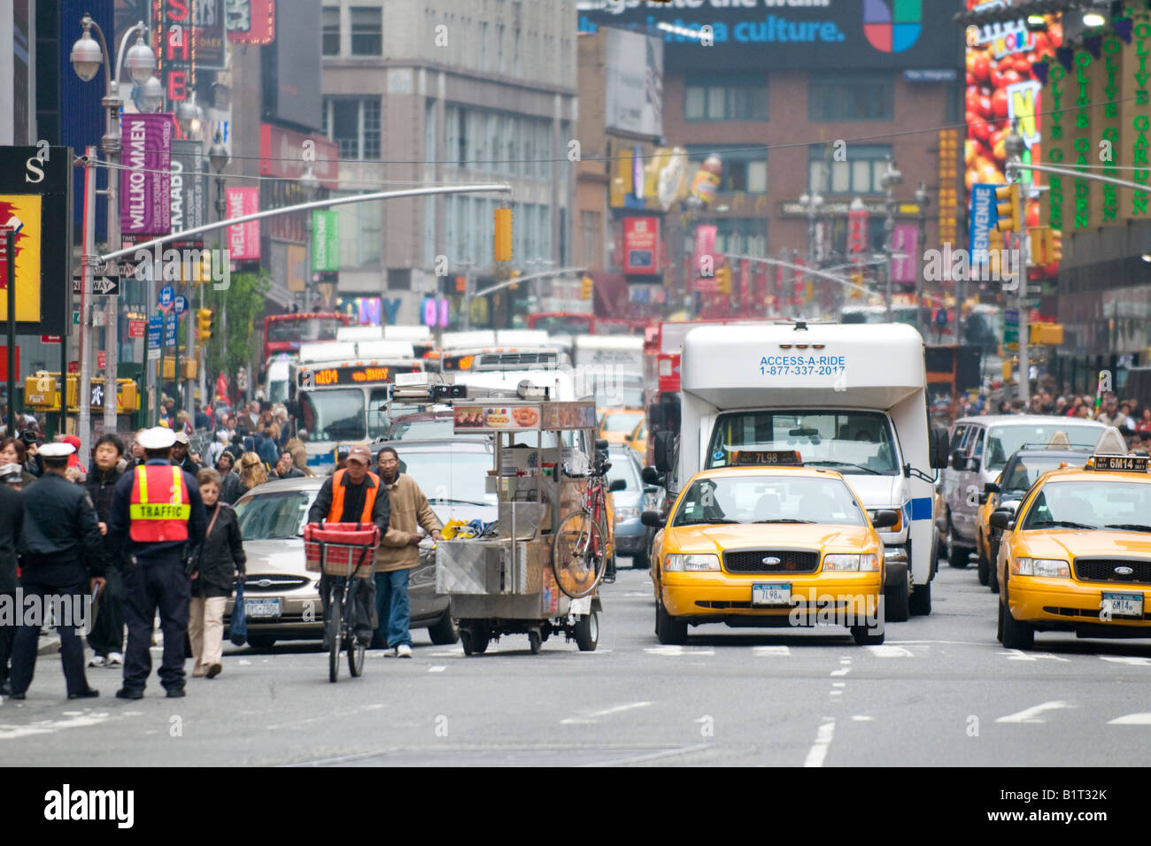 Times Square hustle and bustle with street vendor in traffic Stock Photo