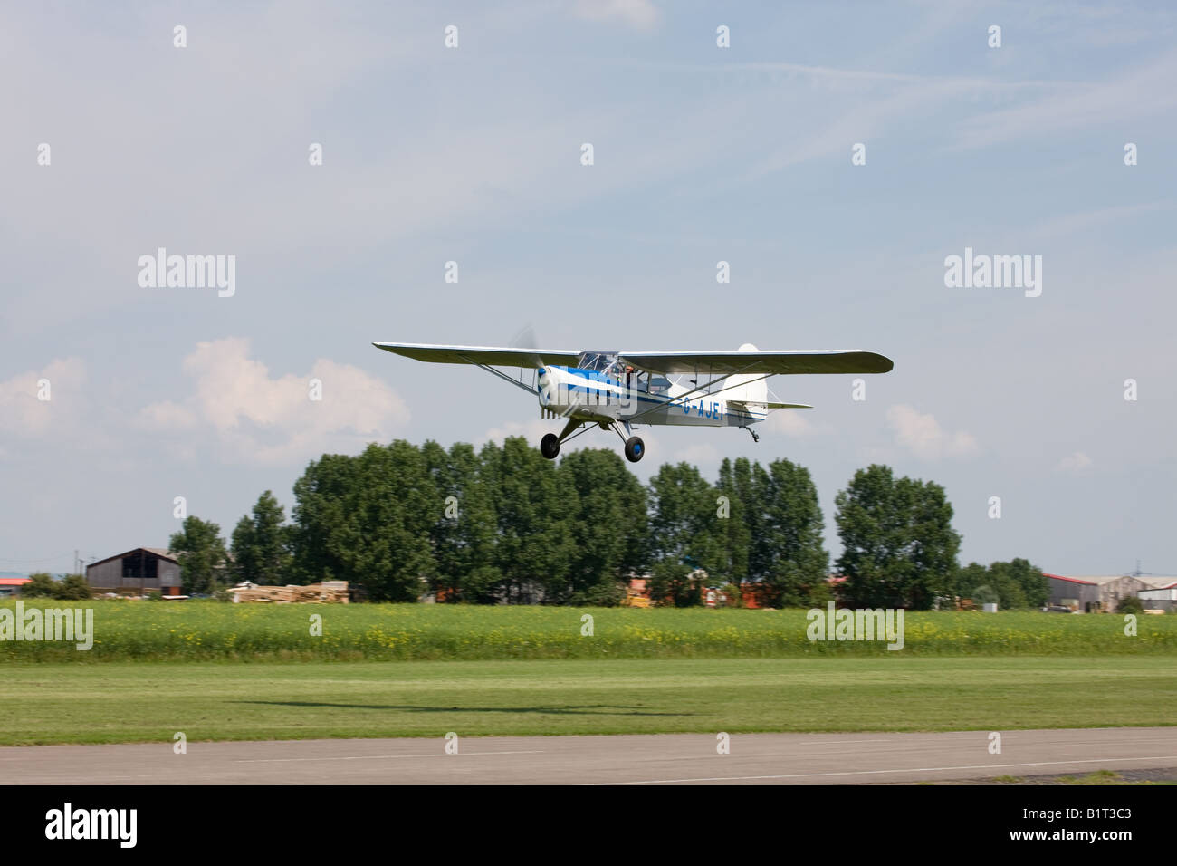 Auster J1N Alpha G-AJEI in flight taking-off from Breighton Airfield Stock Photo