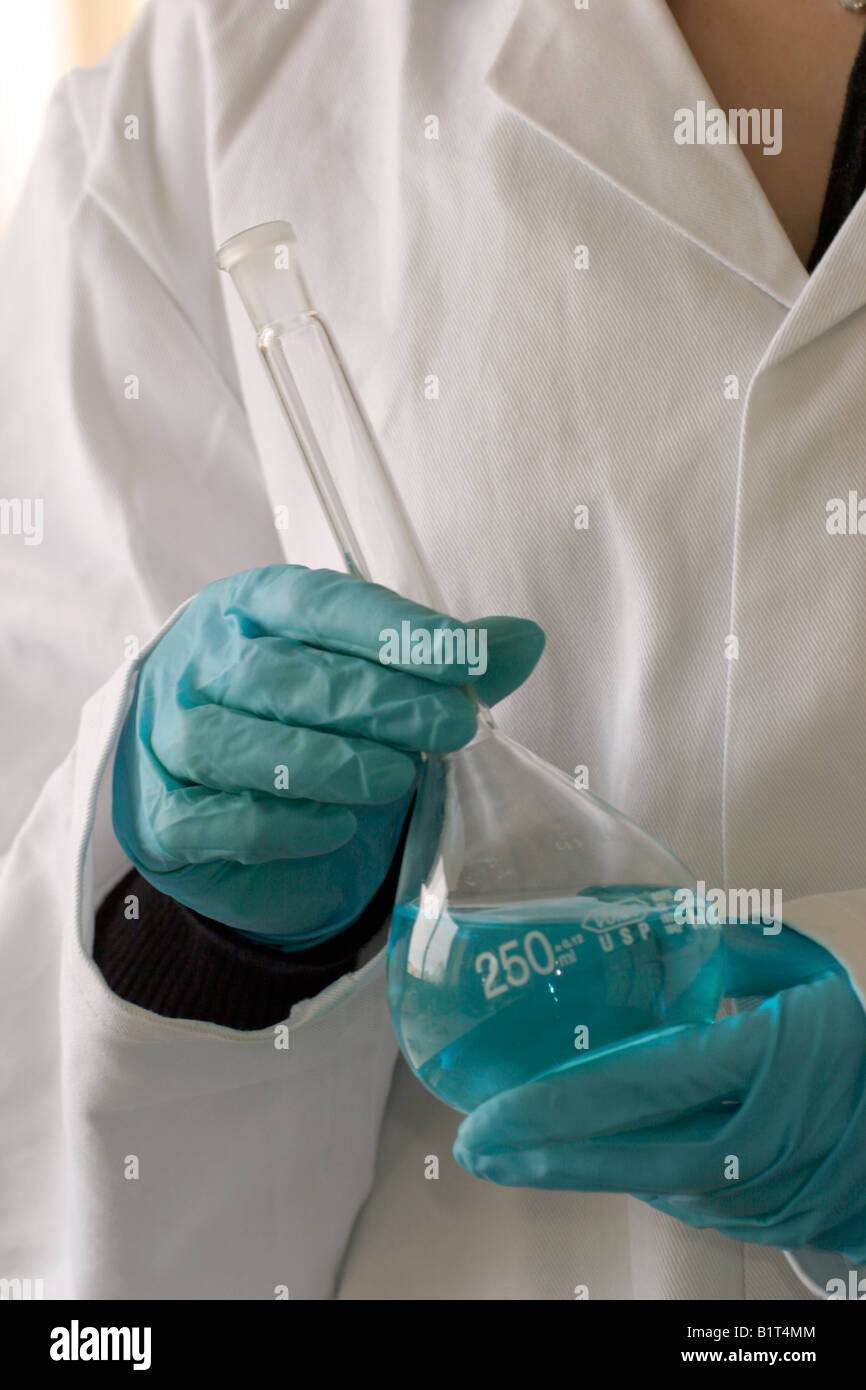 Chemical resistant nitrile gloves being used to handle a volumetric