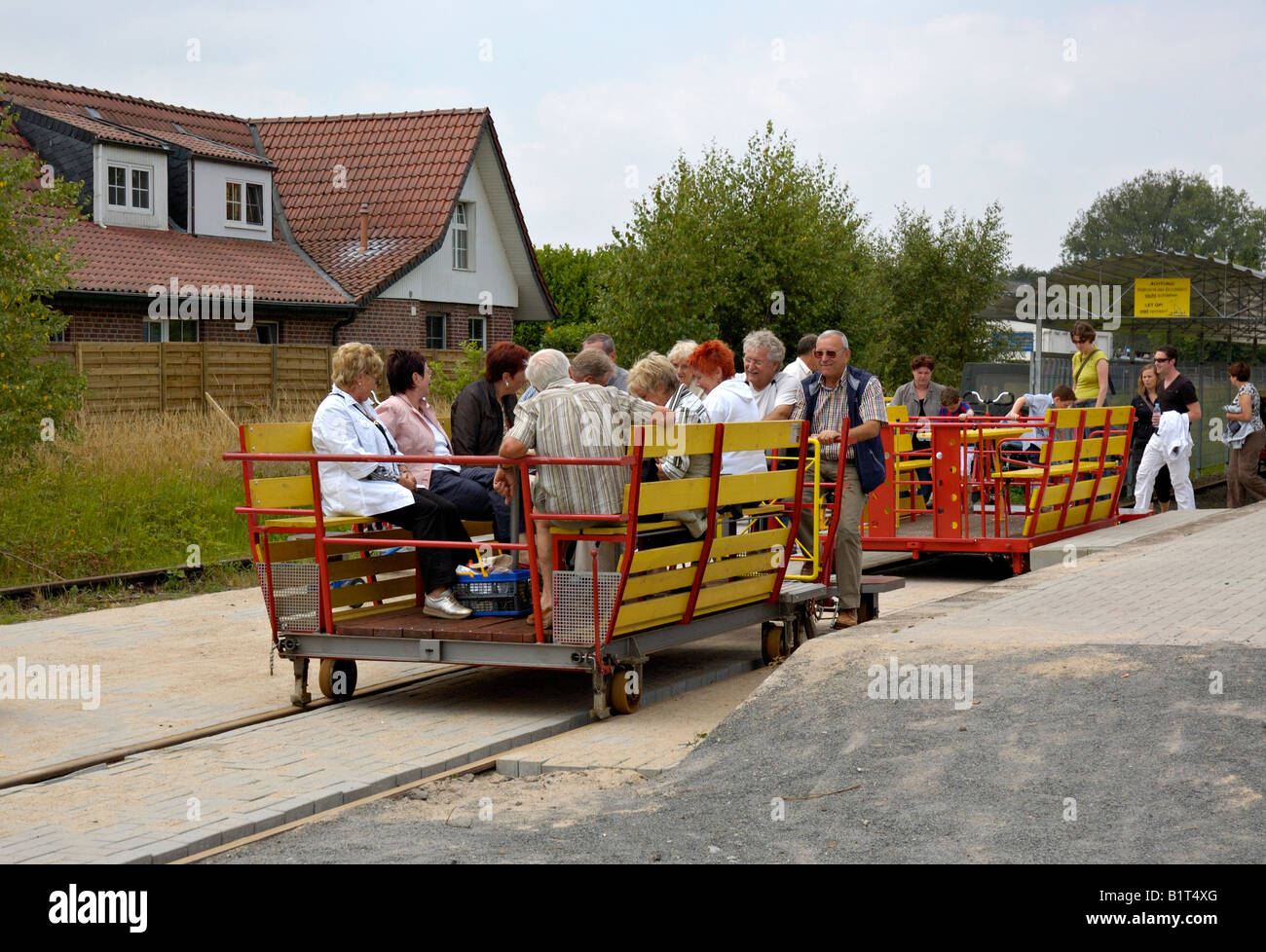 Group of people on a Grenzland Draisine leaving Kranenburg, Lower Rhineland, Germany. Stock Photo