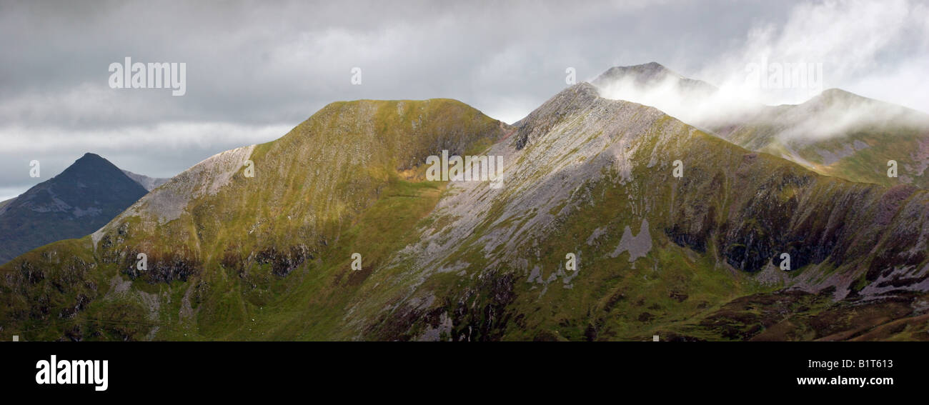 Looking across to the Mamores from Garbh Bheinn with mist streaming off Na Gruagaichean and Binnein Mor Stock Photo