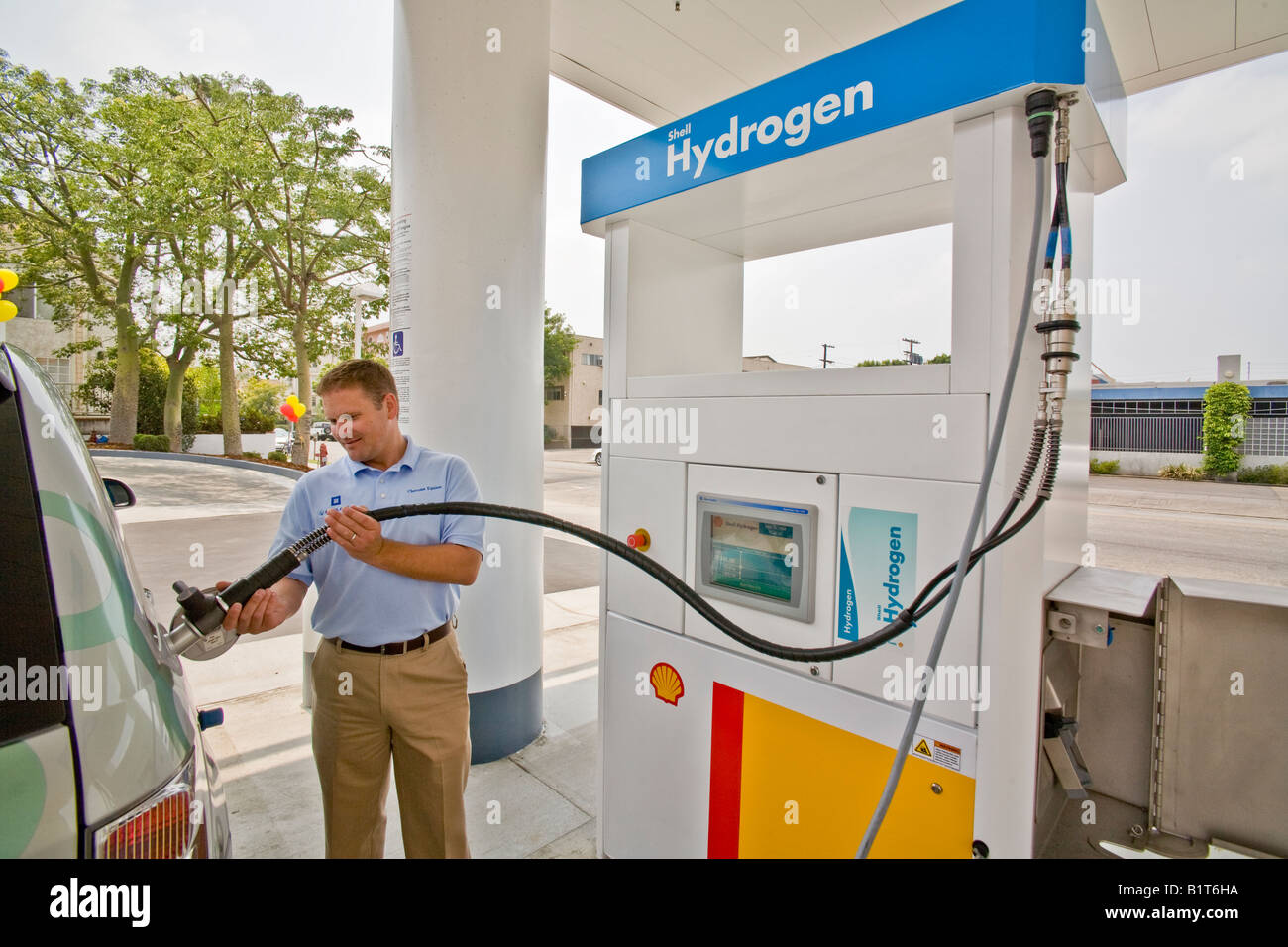 Driver at a hydrogen pump at a Los Angeles gas station prepares to