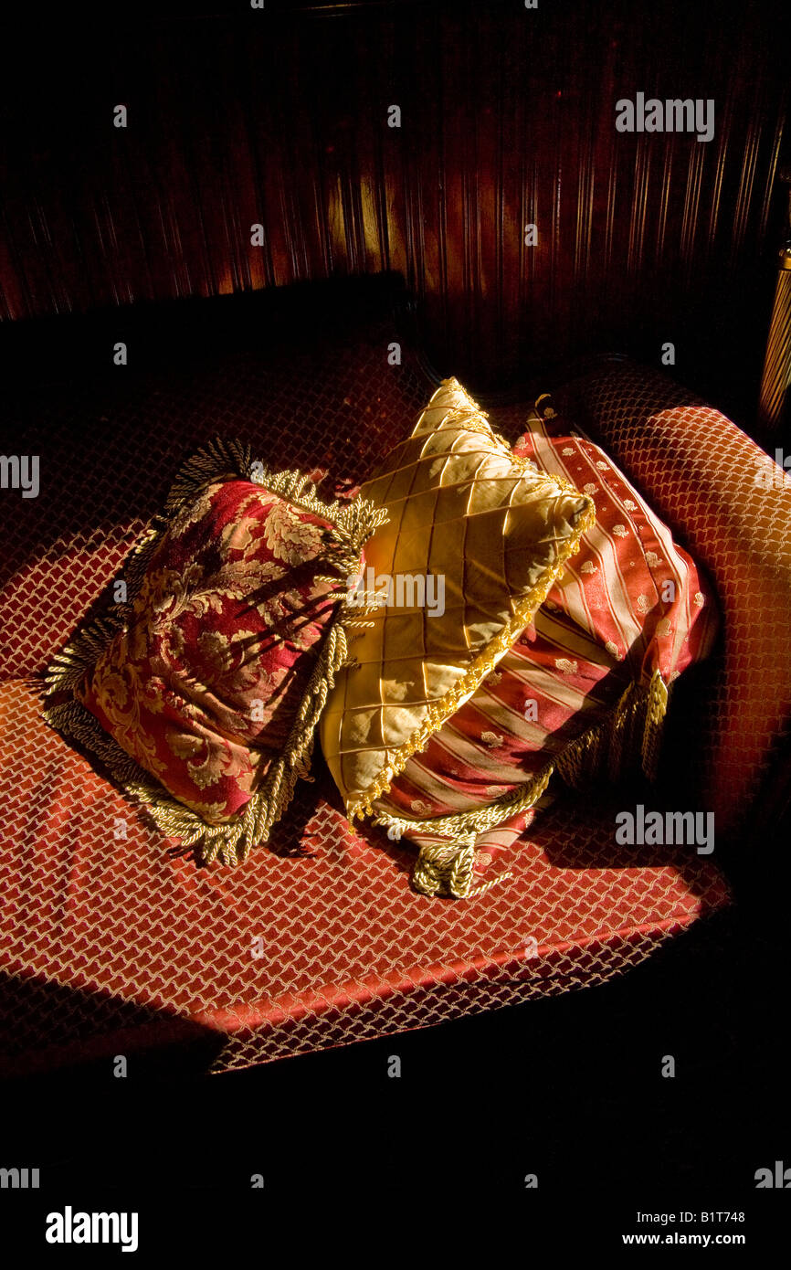 Satin cushions on couch in afternoon sunlight Stock Photo