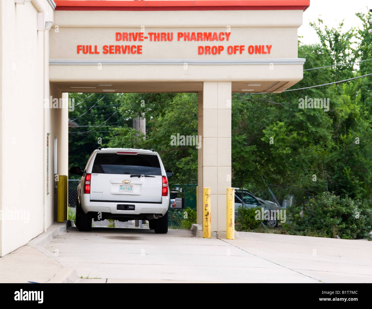 A customer picks up medication from a drivethrough pharmacy in