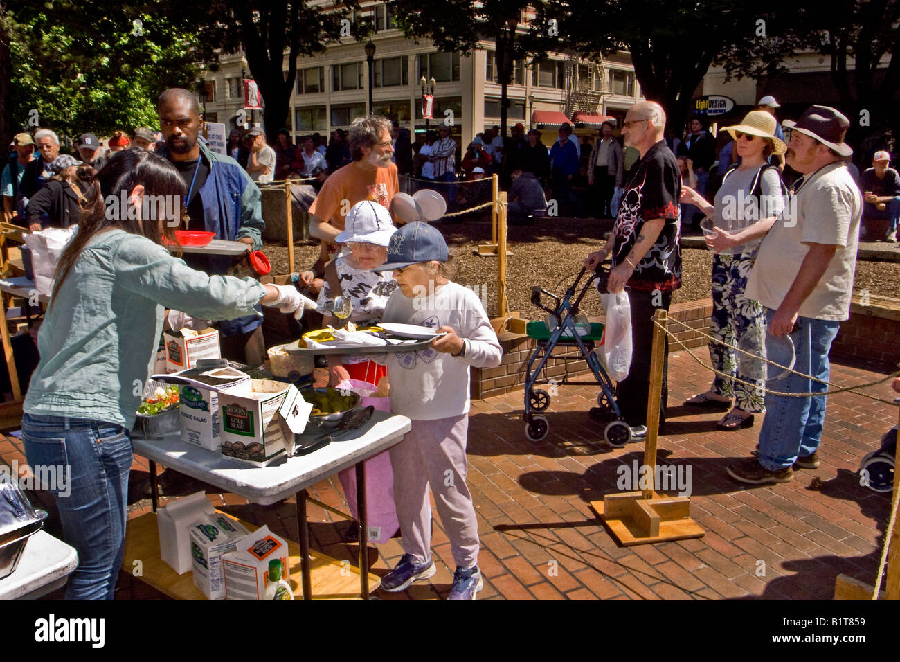 Homeless people line up right background for a free Sunday meal in O Homeless people line up right background for a free Sunday meal in O
