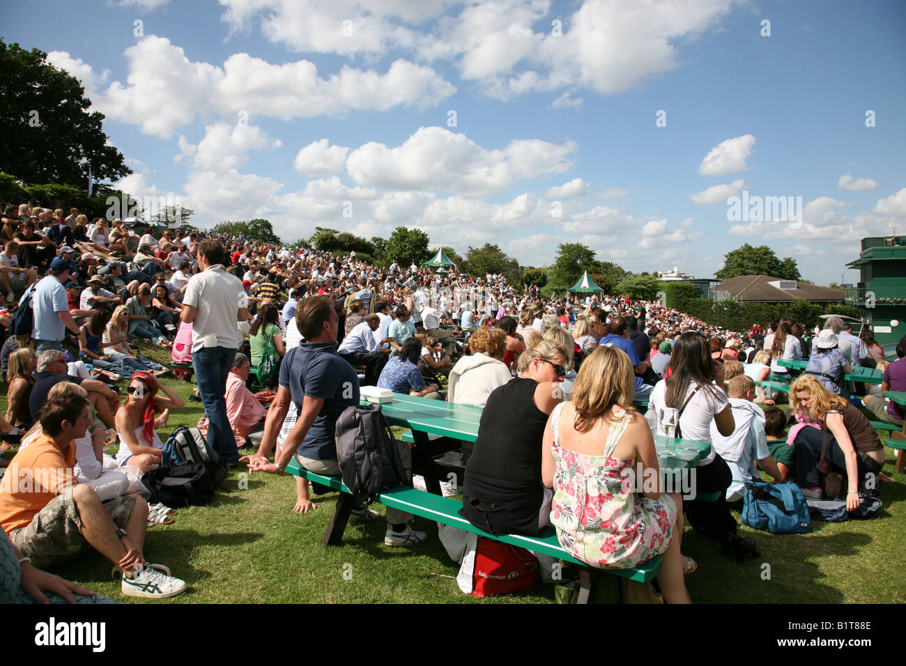 Groups of spectators sitting on Henman Hill at Wimbledon Tennis Championships Stock Photo