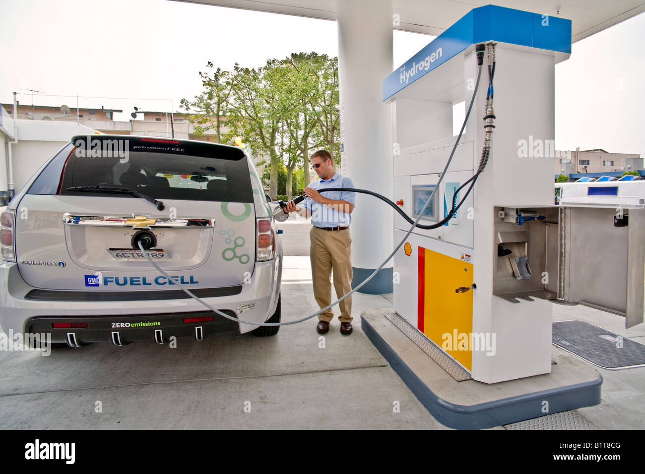Driver at a hydrogen pump at a Los Angeles gas station prepares to