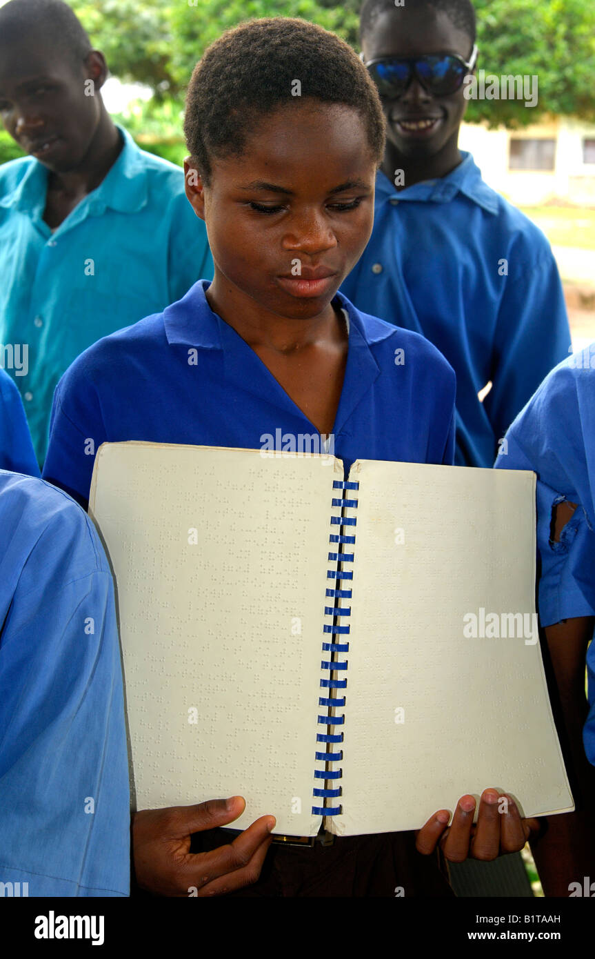 A female student of the Akropong School for the Blind shows a text book written in Braille script, Akropong, Ghana Stock Photo