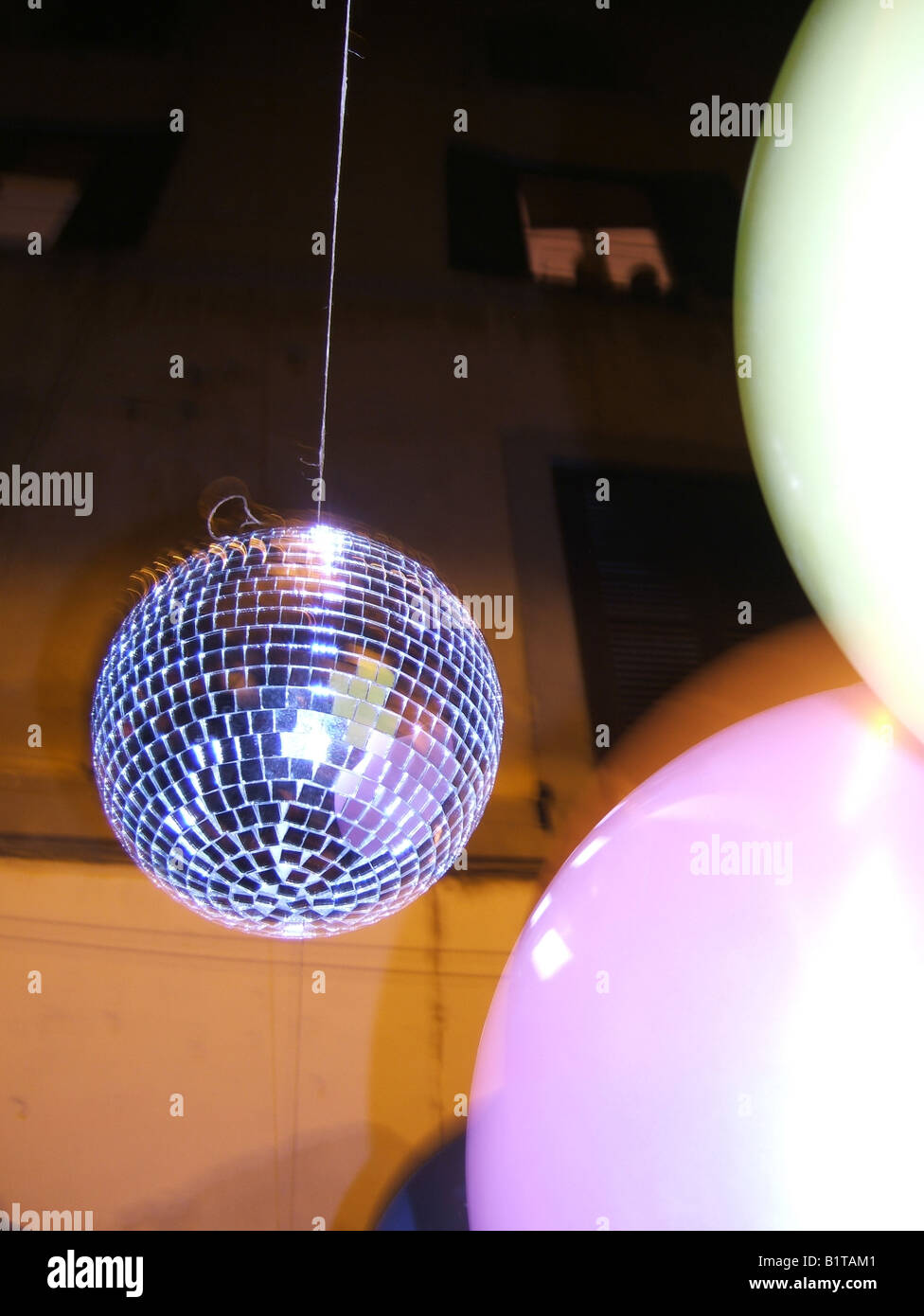 one illuminated glitter ball street party at night Stock Photo Alamy