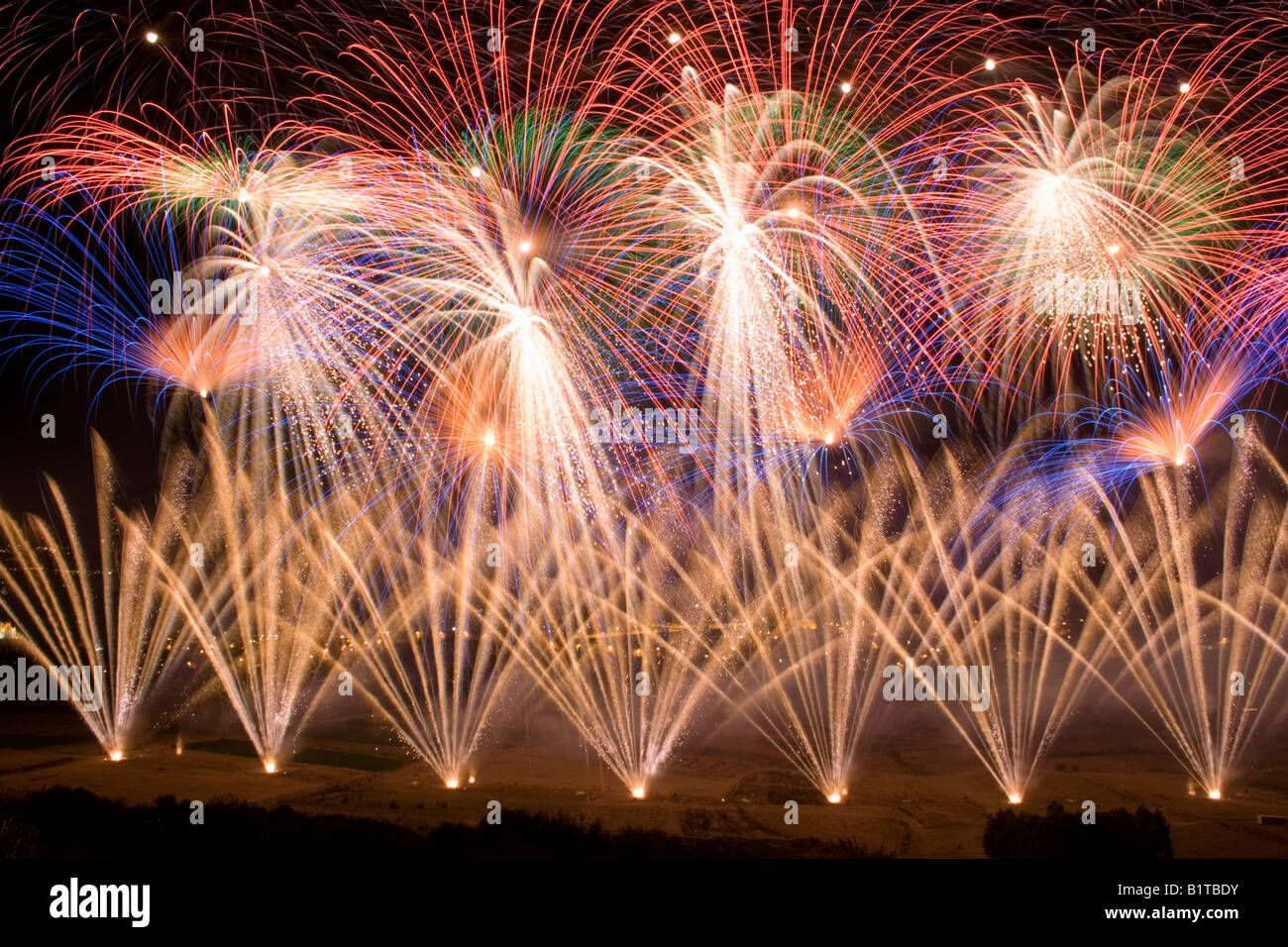 Synchronised fireworks exploding during the annual feast at Nadur, Gozo Stock Photo