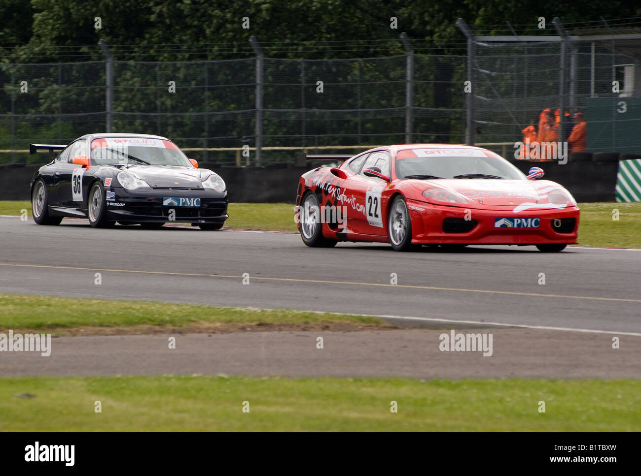 Ferrari 360 GT and Porsche 996 GT3 Sports Race Cars Exiting Old Hall Corner Oulton Park Motor Racing Circuit Cheshire England Stock Photo