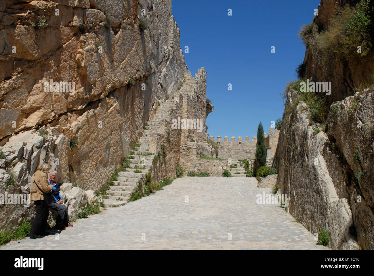 tourist couple inside Almansa Castle, Almansa, Albacete Province, Castile-La-Mancha, Spain Stock Photo