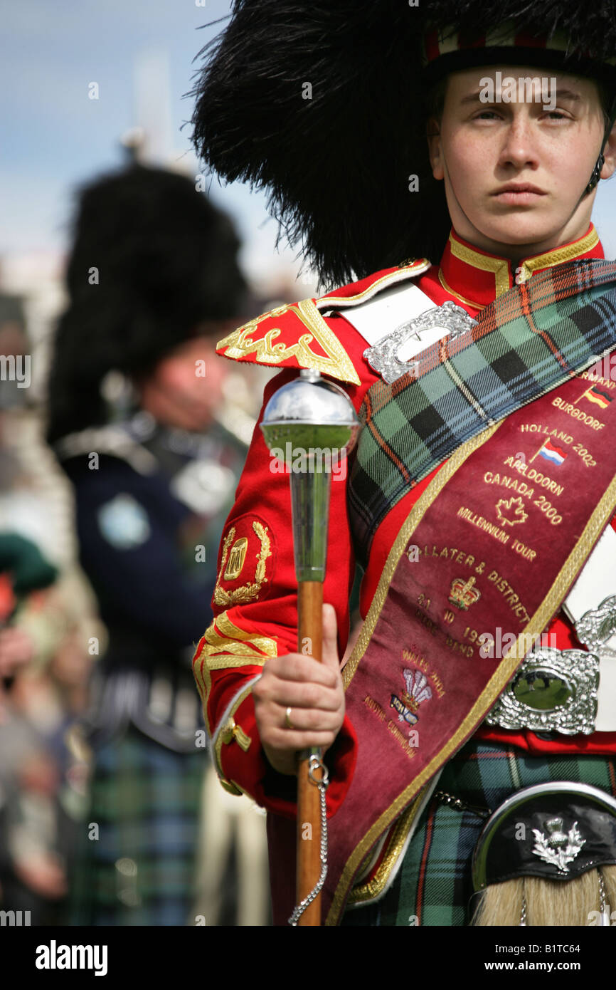 Village of Braemar, Scotland. Female Pipe Major leading her band in the
