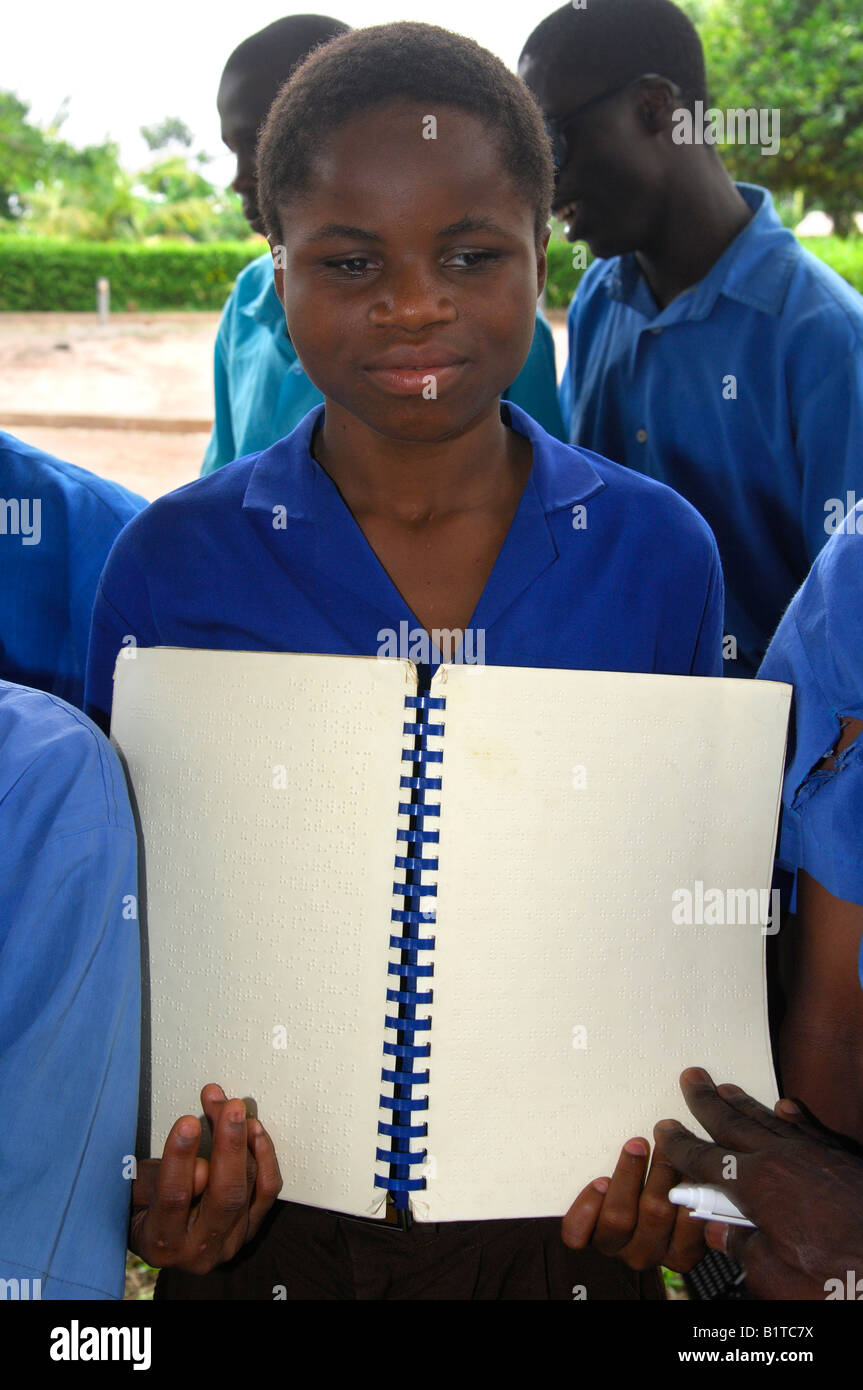 A female student of the Akropong School for the Blind shows a text book written in Braille script, Akropong, Ghana Stock Photo
