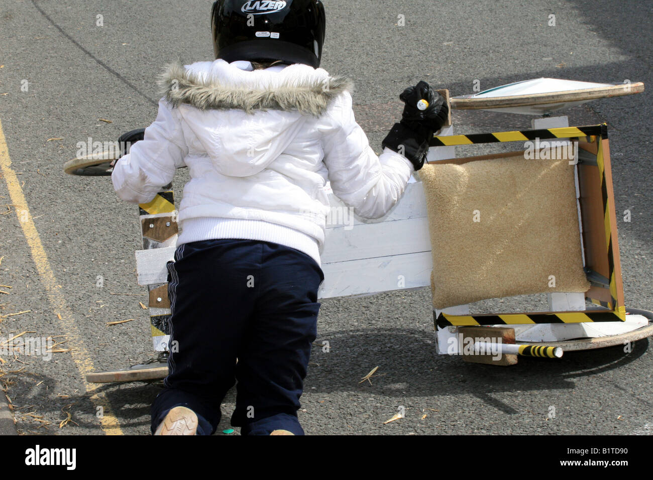 Girl has a spill from her soapbox racer Stock Photo