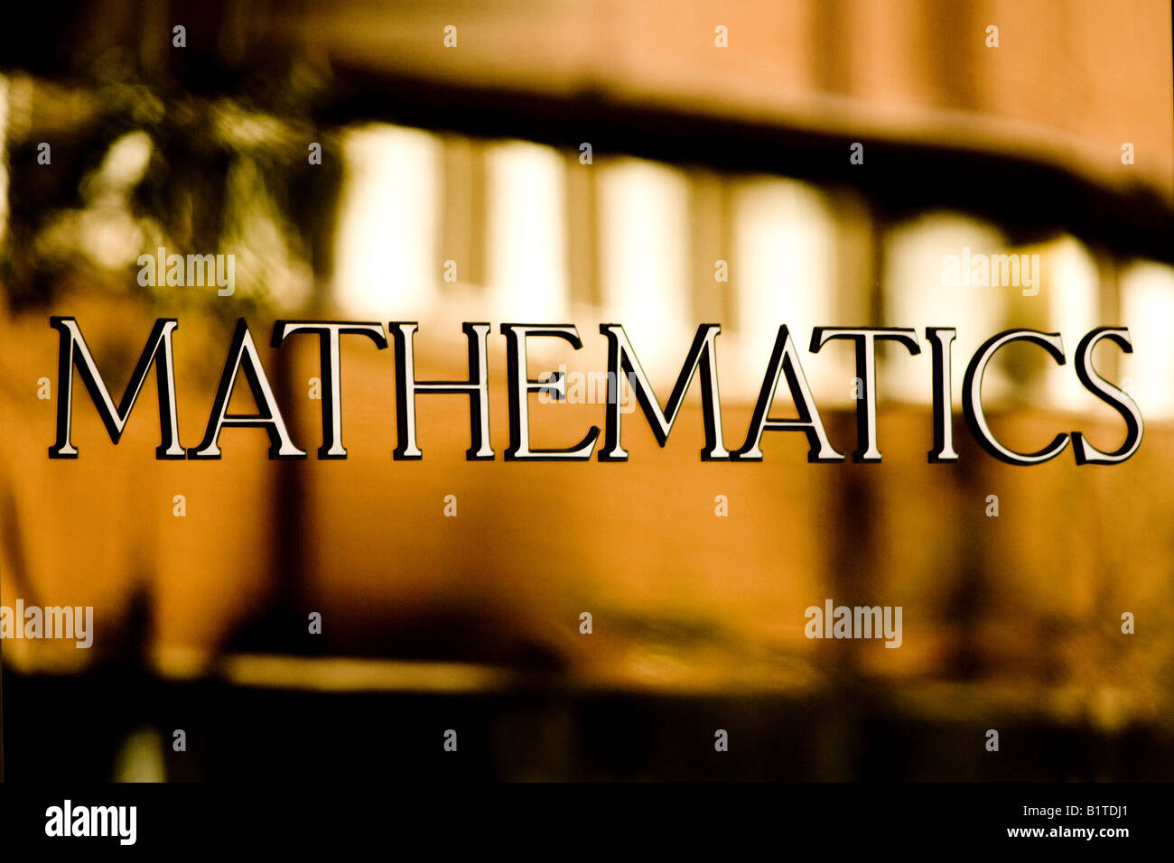 Mathematical symbol displayed on the door of a building of higher learning, representing knowledge, education, and academic study. Stock Photo