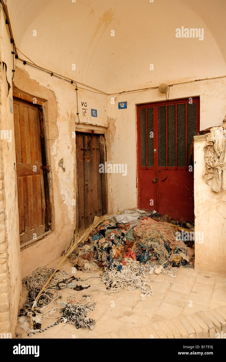 Waste wool debris left outside a small closed carpet making factory in