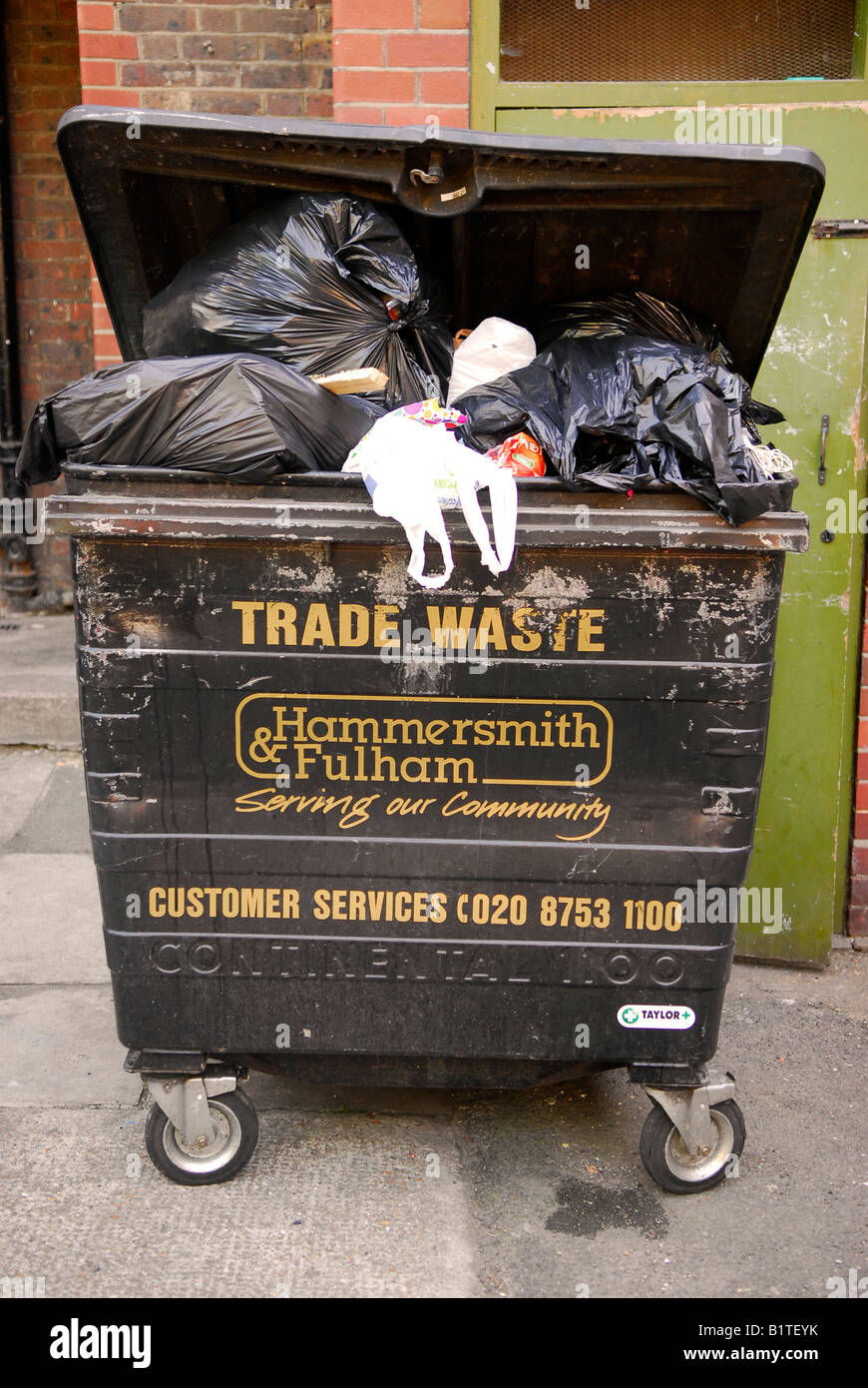Overflowing waste bin on council housing estate Fulham west London UK Stock  Photo - Alamy