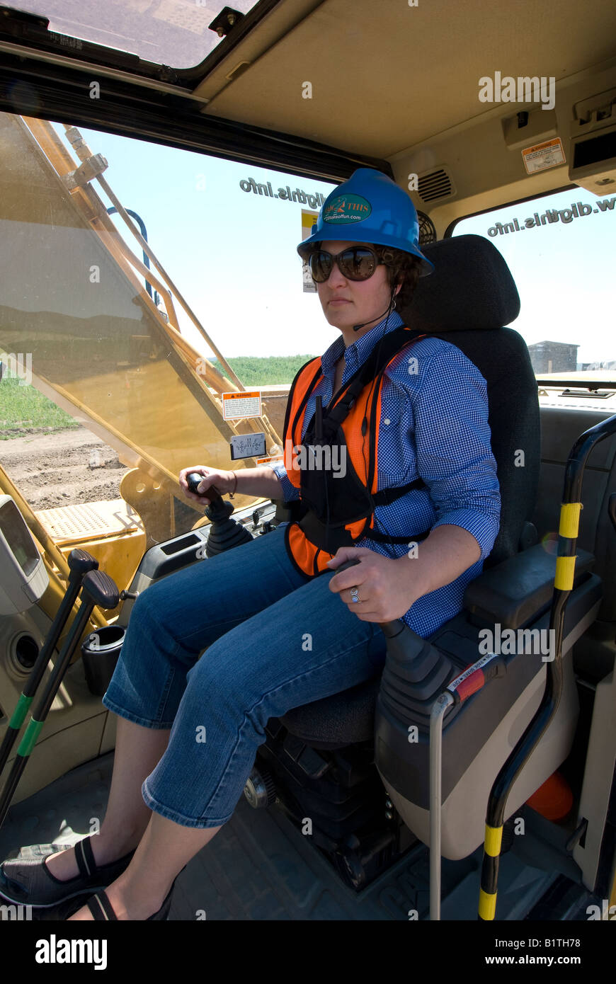 Woman at the controls of a Caterpillar 315CL track excavator, Dig This