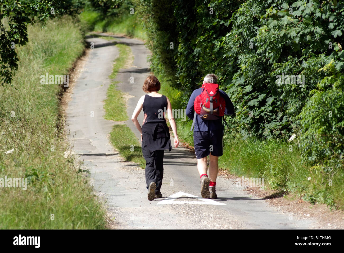 Walkers on a country lane in the Cotswolds Gloucestershire England Stock Photo Alamy