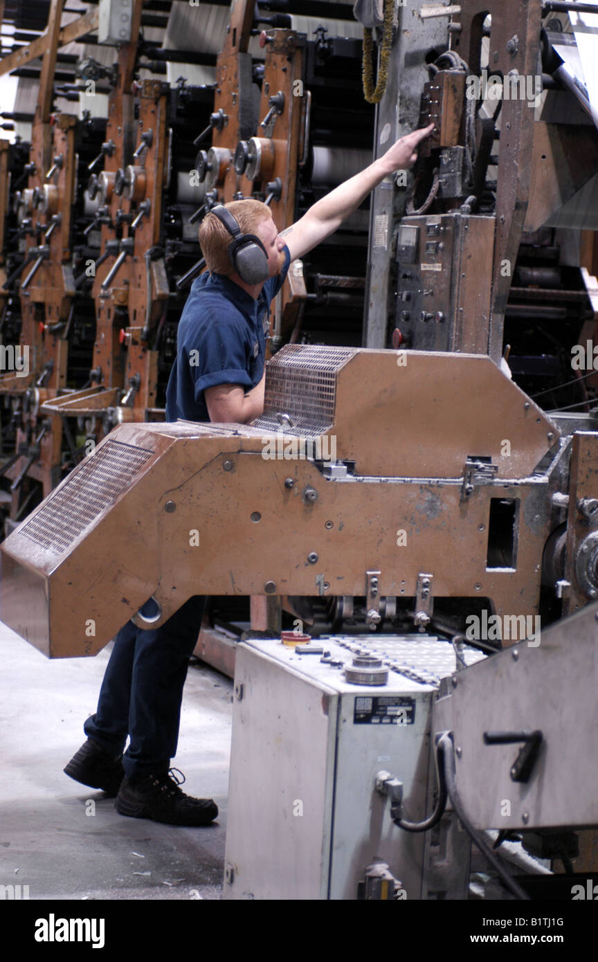Pressman by the Quad Stack printing machine Stock Photo Alamy