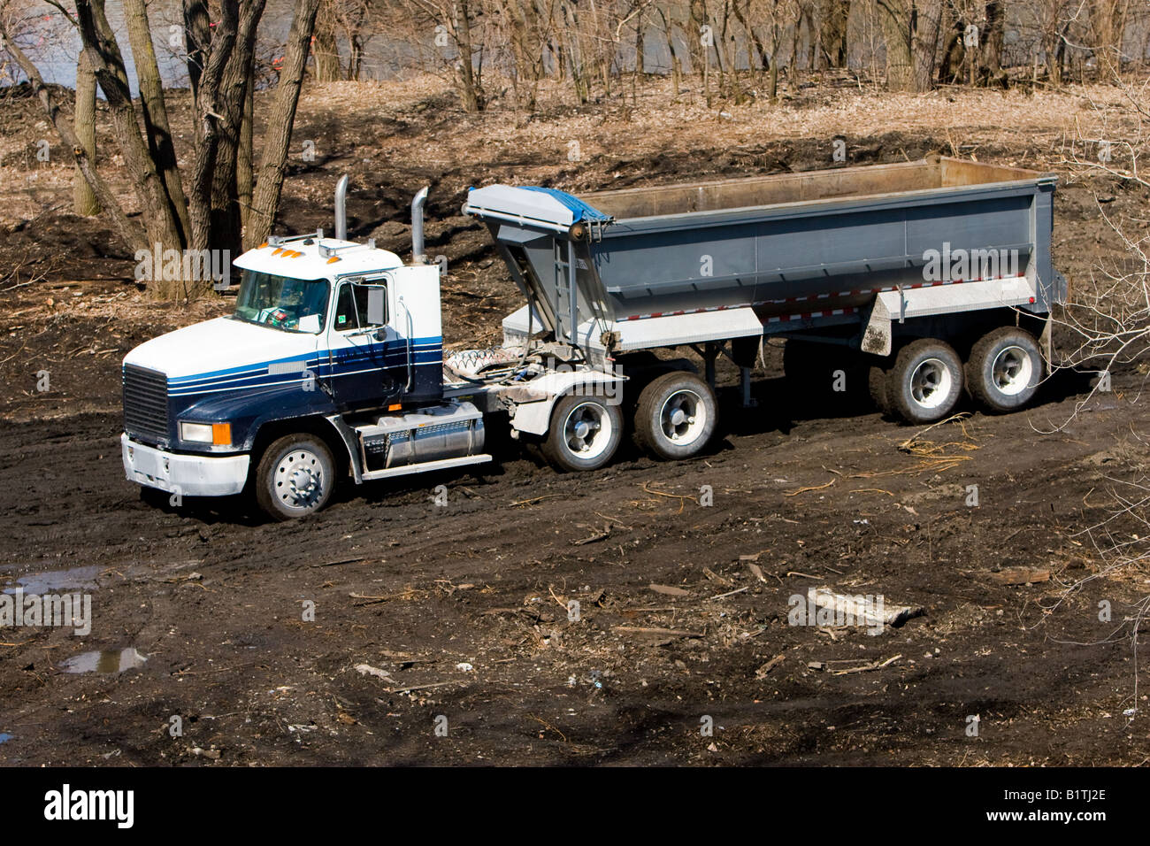 A semi truck hauling dirt at a construction site in Chicago, IL Stock