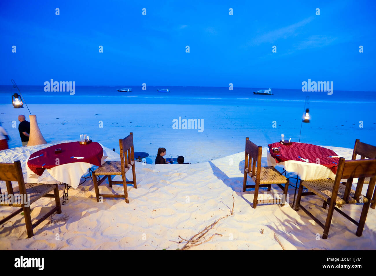 People passing a beach restaurant The Sands at Nomad Diani Beach Kenya Stock Photo