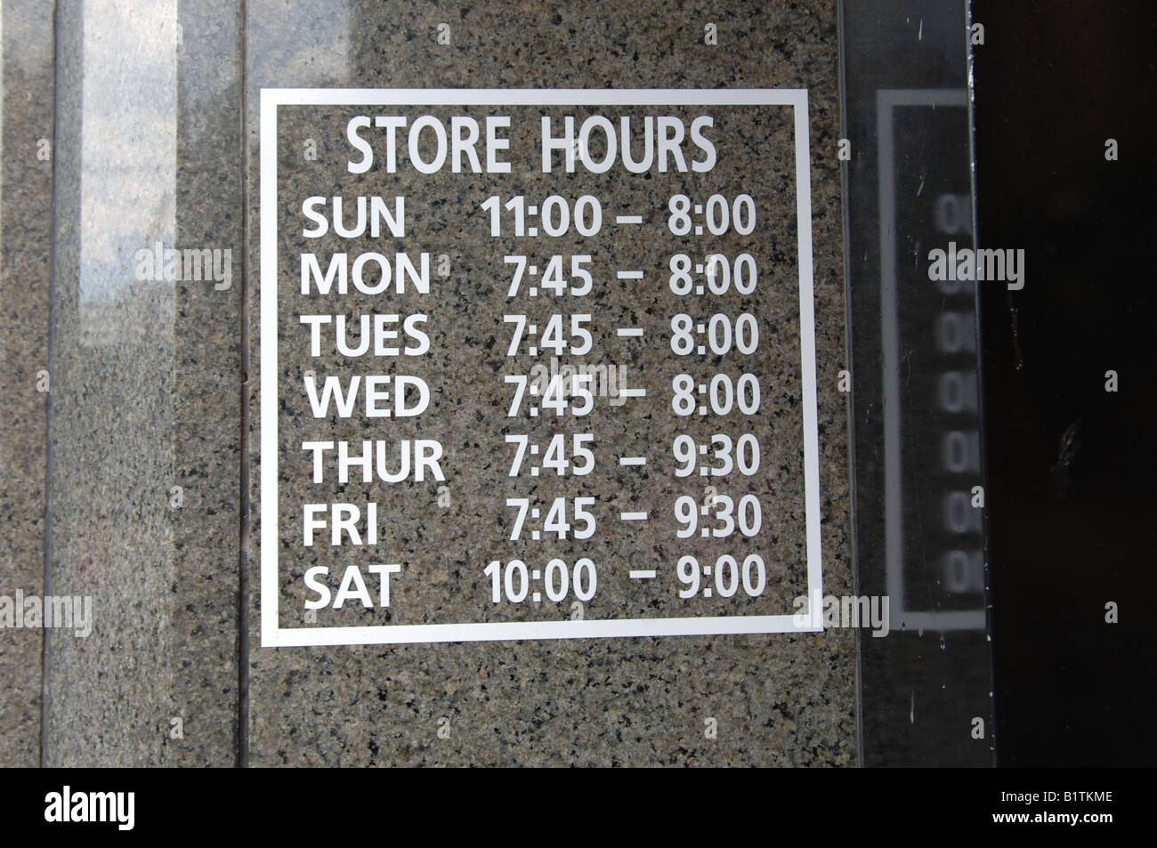 Store hours sign for Century 21 Department store in Lower Manhattan Stock Photo