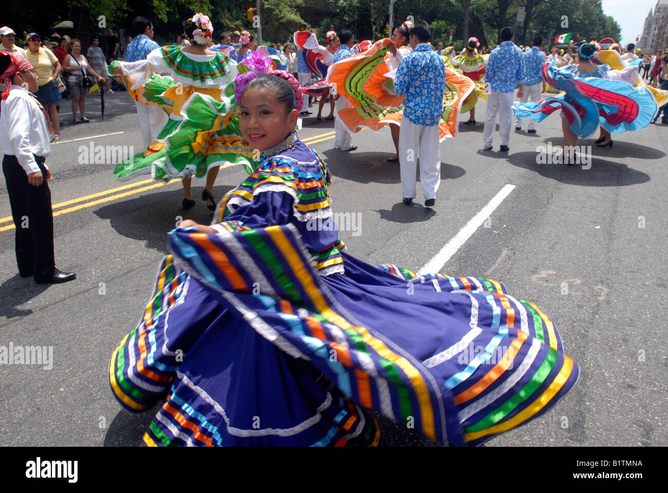 Colombian folk dancers perform in a flower parade on Central Park West