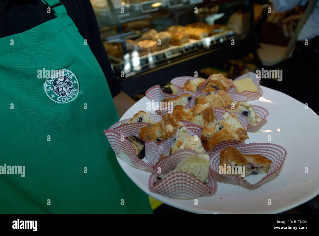 Starbucks employees pass out samples at the opening of a new coffeehouse in Harlem in New York Stock Photo