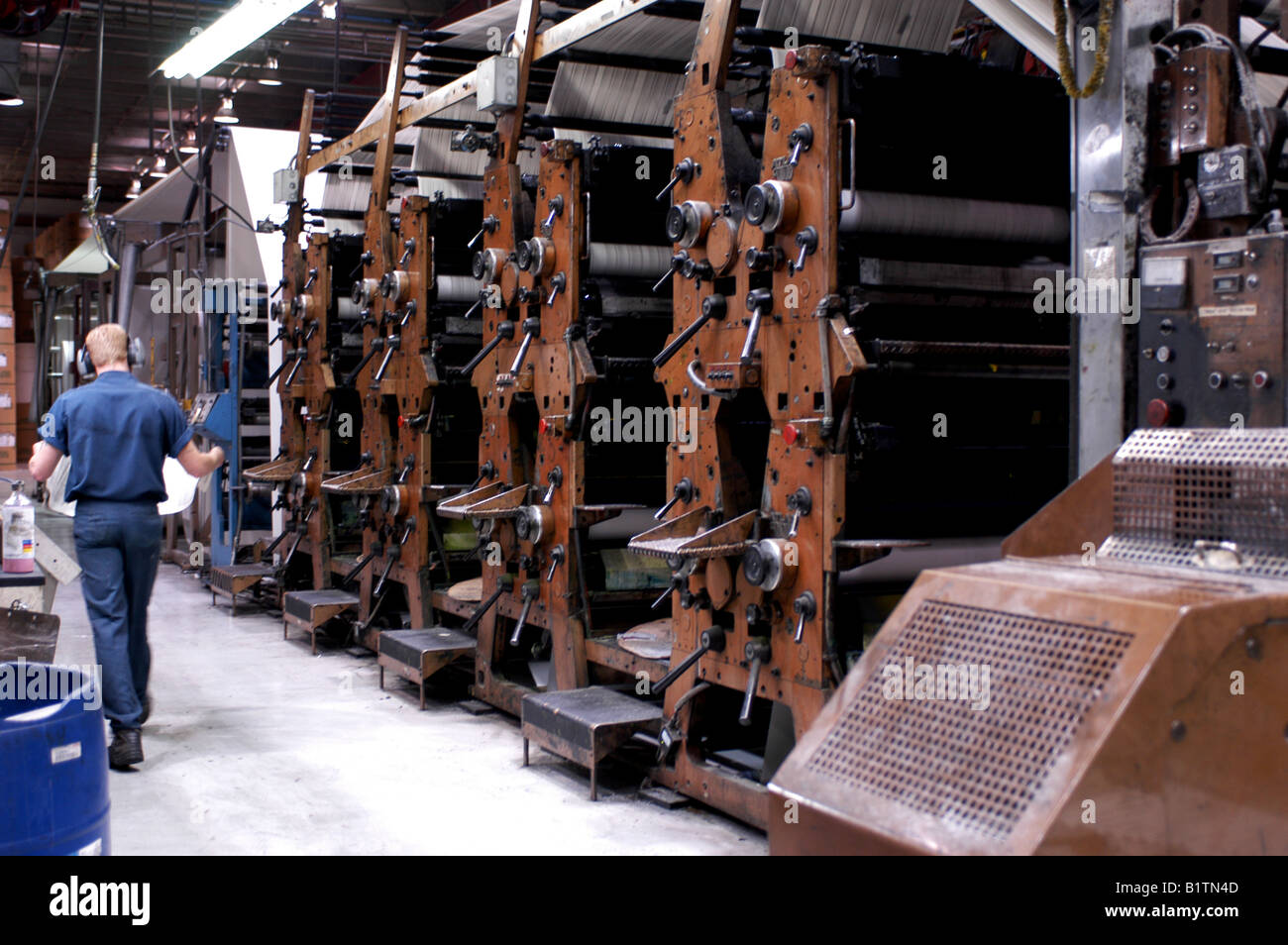 Pressman by the Quad Stack printing machine Stock Photo Alamy
