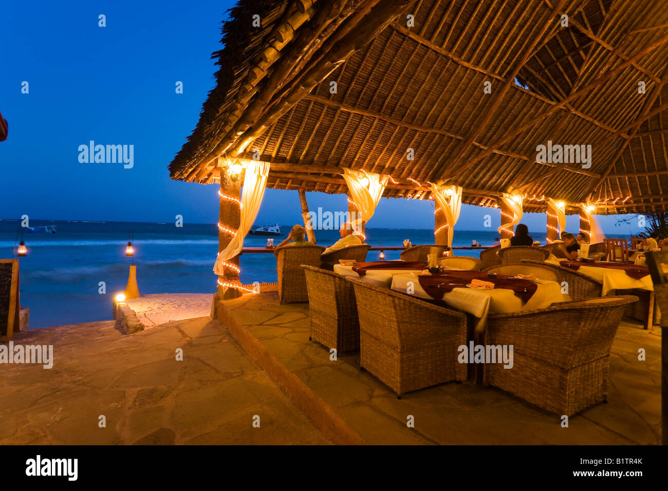 Couple sitting in a beach bar The Sands at Nomad Diani Beach Kenya Stock Photo