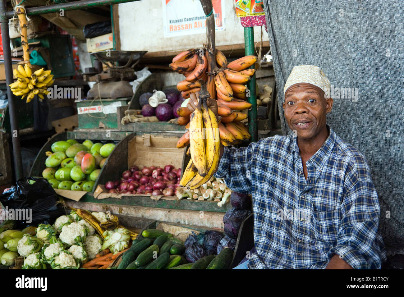 Seller offering bananas in market hall central market Mombasa Kenya Stock Photo