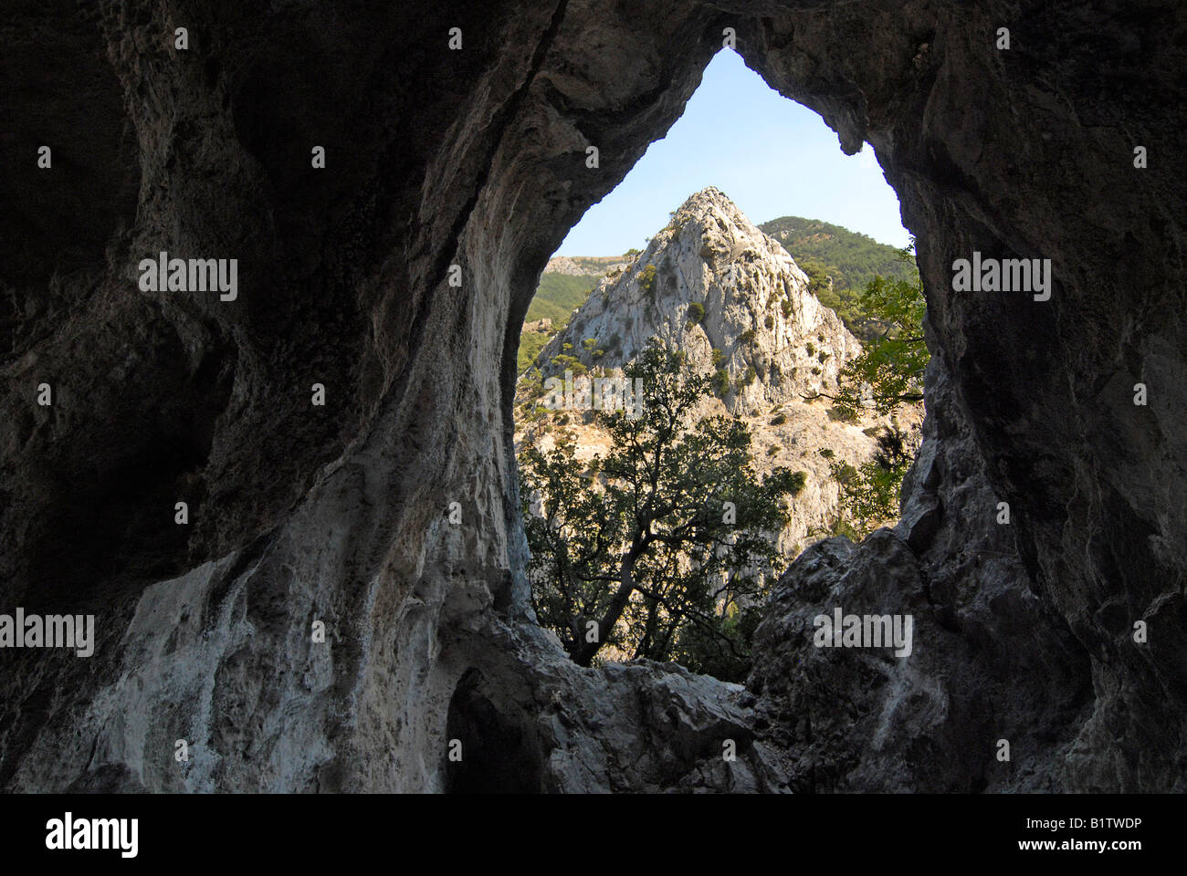 View out of a cave on the flanks of Kako Perato Canyon. Island of Samos in Greece. Stock Photo